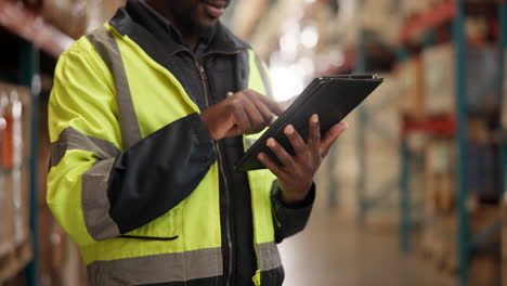 warehouse worker using tablet for inventory management