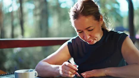 woman drawing on digital tablet outdoors