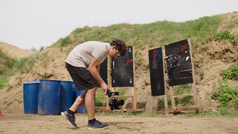 Male-with-bent-back-and-camera-on-gimbal-stabilizer-walk-at-Olesko-shooting-bay