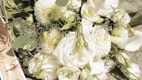 gorgeous bridal wedding flat lay with high heals, earings, and a beautiful bouquet of white flowers
