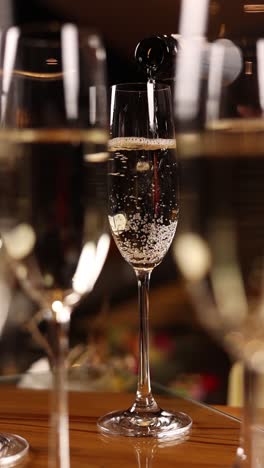 champagne pouring into flute glasses