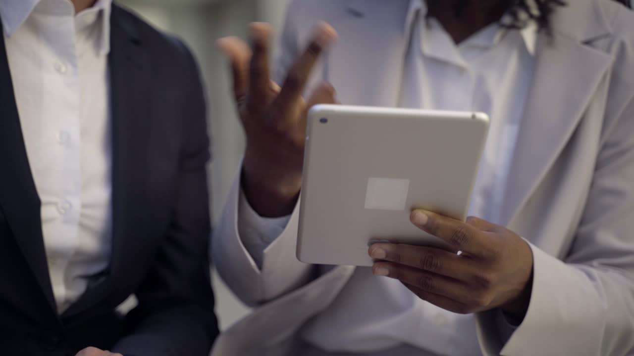 Cropped shot of businesswomen with tablet pc