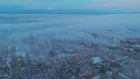 santo domingo in fog: aerial views of the city’s skyline and streets covered in morning mist and low visibility