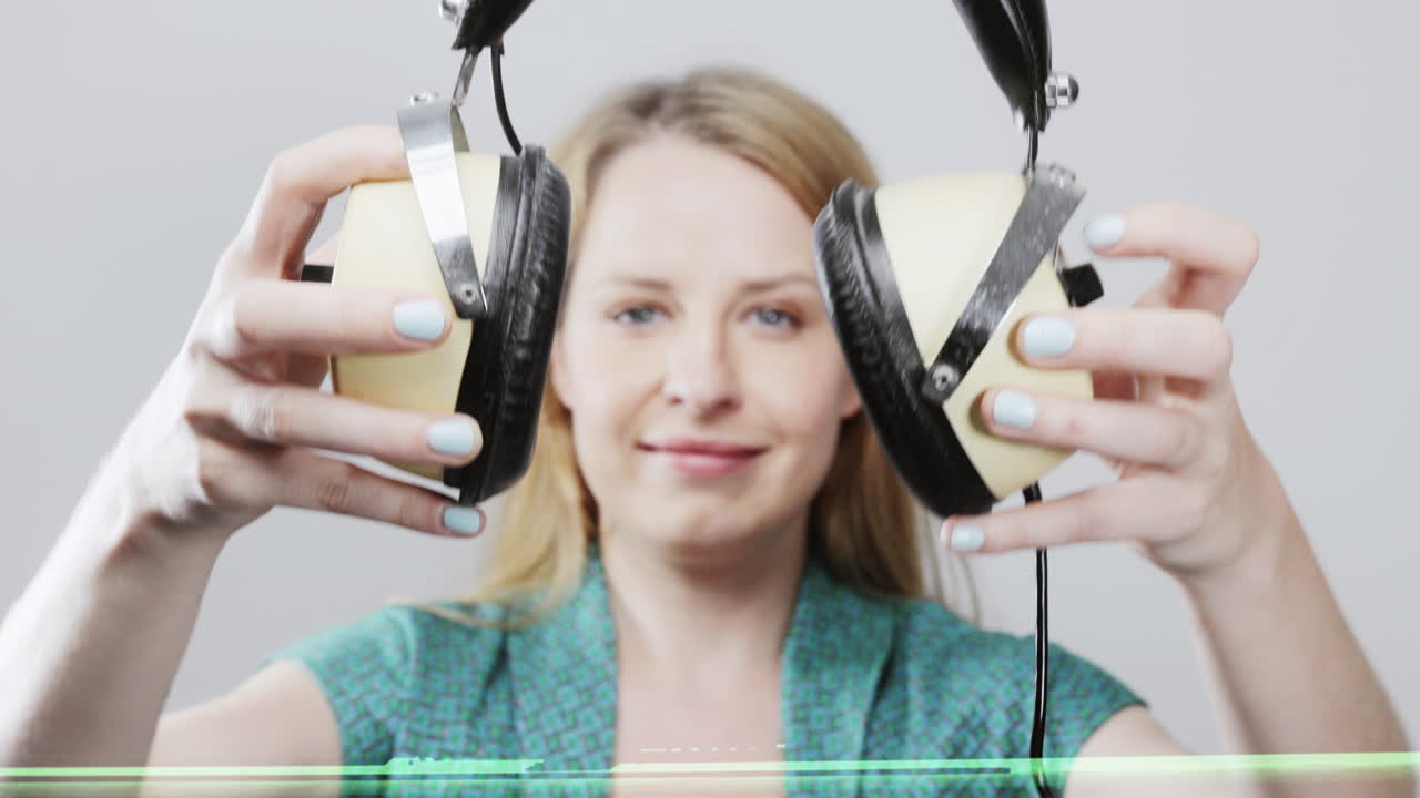 cool female dancer with changing retro headphones to listen to music