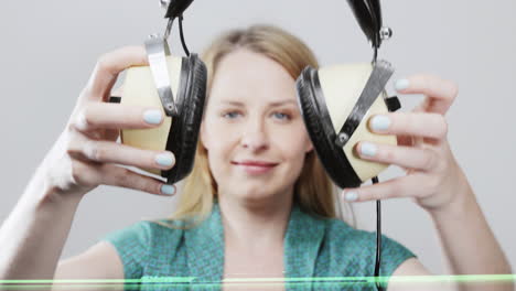 cool female dancer with changing retro headphones to listen to music
