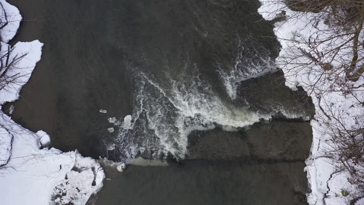 icy winter river mini waterfall overhead static view