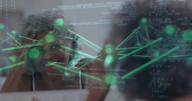 senior woman focusing at desk, interacting with holographic neural network code in tech environment