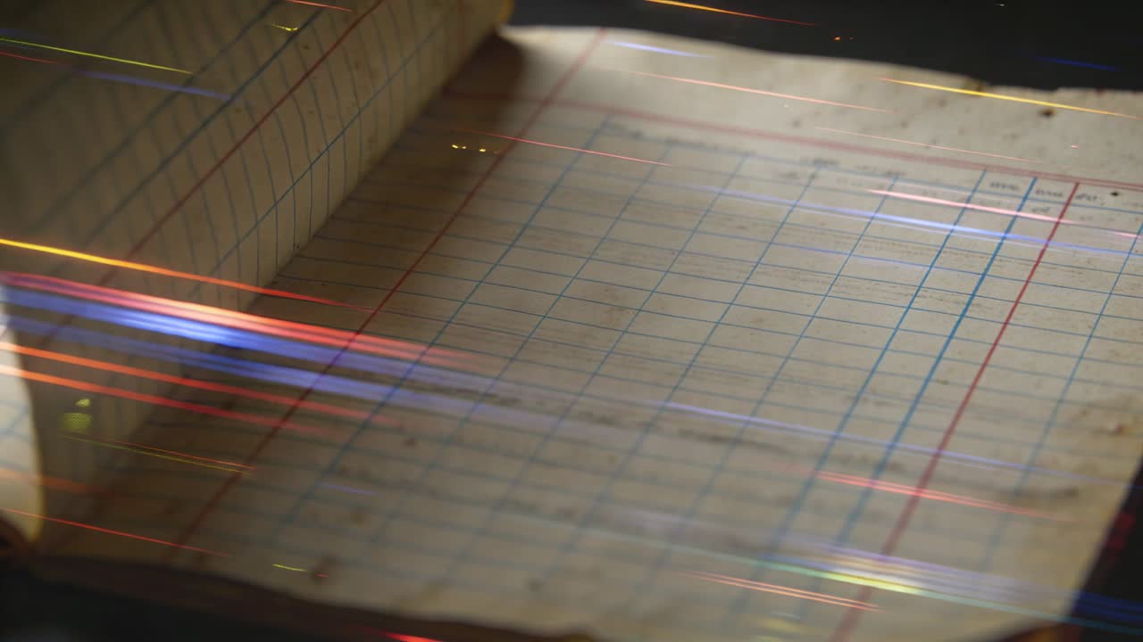 Revealing open ledger with ruled columns resting on dark desk, passing lights casting streaks