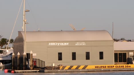 sunset view of a coastal helipad and building