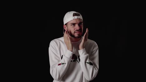 trendy 20s man shooked and surprised gesture, wide, black background