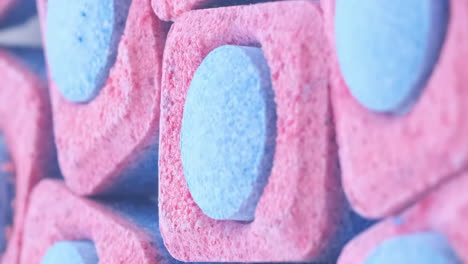 capsules of bluered color for washing dishes in an automatic machine vertical video