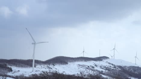 Wind-power-plants-are-seen-in-the-snow-covered-mountain,-South-Korea