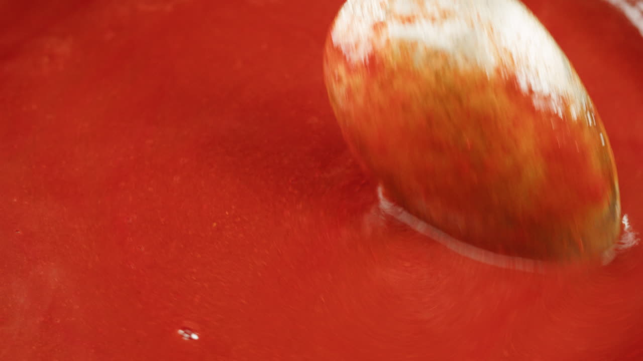 Chicken in tomato sauce is boiling on a frying pan with spices. Cooking tomato sauce curry with chicken fillet. Traditional Italian Mexican Asian dish. High quality studio shot for cafe, restaurant close up.