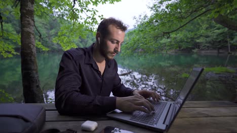 businessman working with laptop in nature.