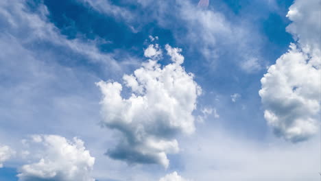 beautiful fluffy clouds changing shape in the sky. soft cloudscape in the rays of bright sun timelapse.
