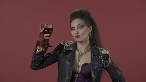 woman in 80s rock style posing with wine glass