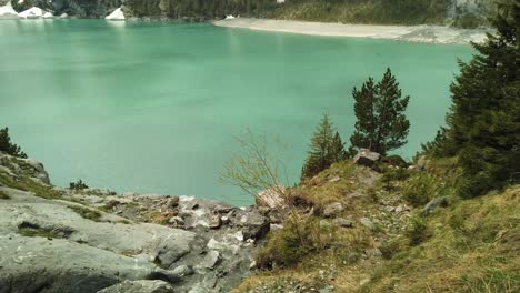 peaceful alpine river flows into the turquoise oeschinensee in switzerland