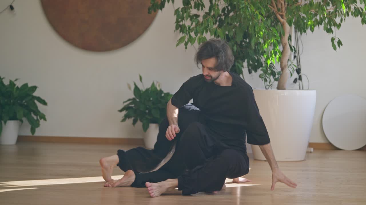 Couple practicing yoga poses indoors