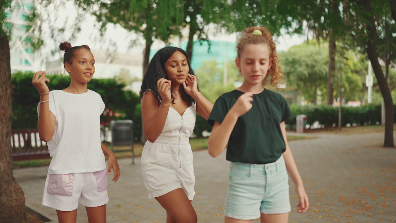 Three Teenage Girls Dancing in a Park