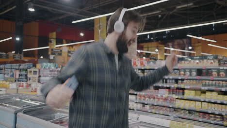 man dancing in grocery store with headphones