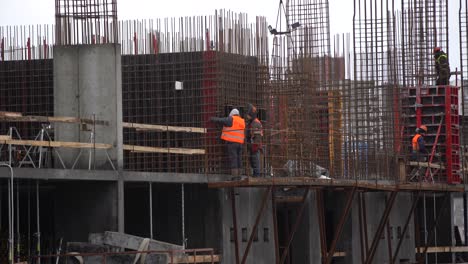 construction of modern high-rise buildings in wintertime. aerial view from flying drone