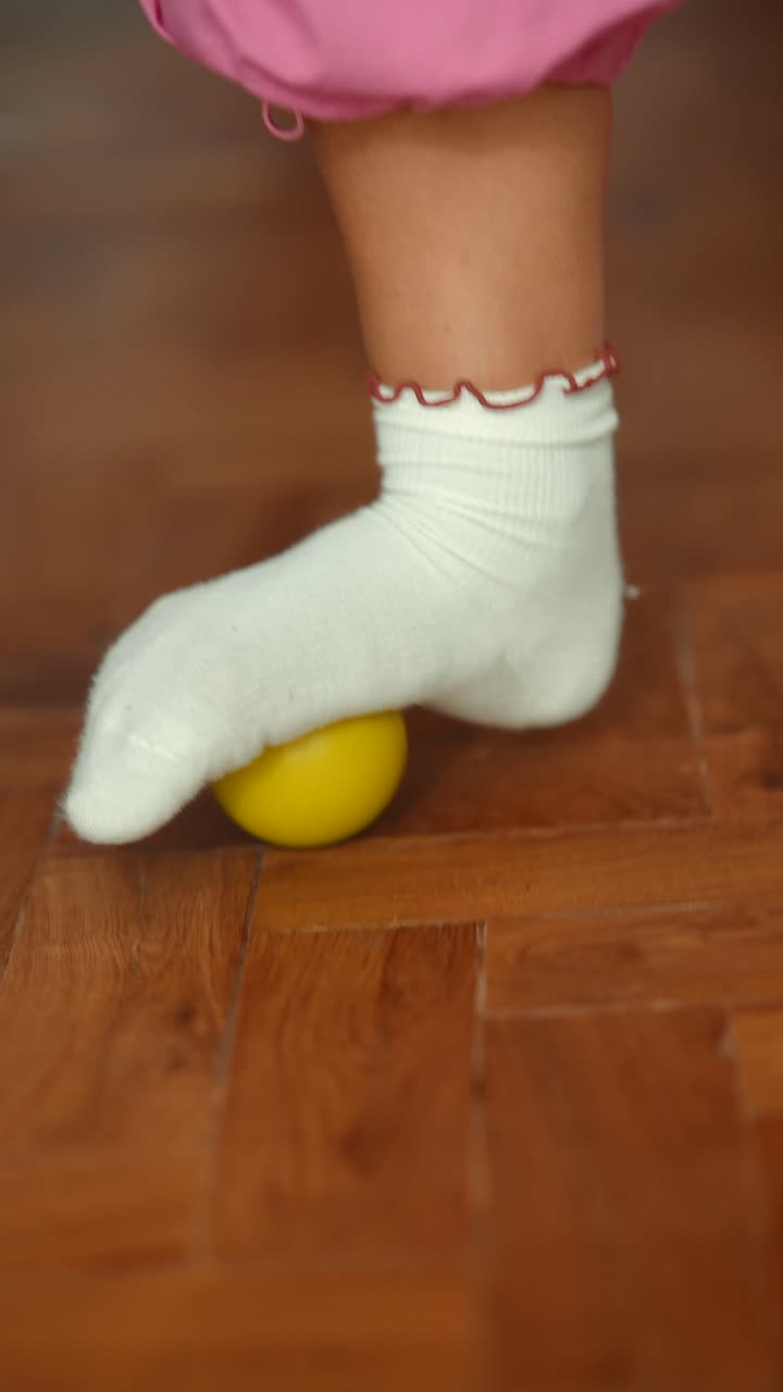 Child's foot with a sock and ball