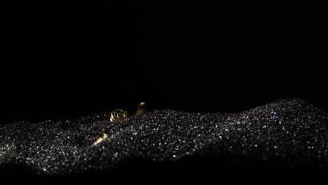 gunpowder dust with 9×19mm parabellum bullet falling over, detail macro shot