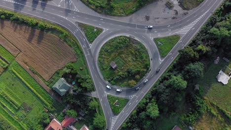roundabout traffic of cars and trucks on the circle ring road aerial top view.