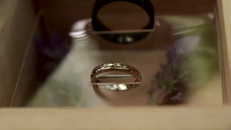 close up tilt shot of a man and woman's wedding rings