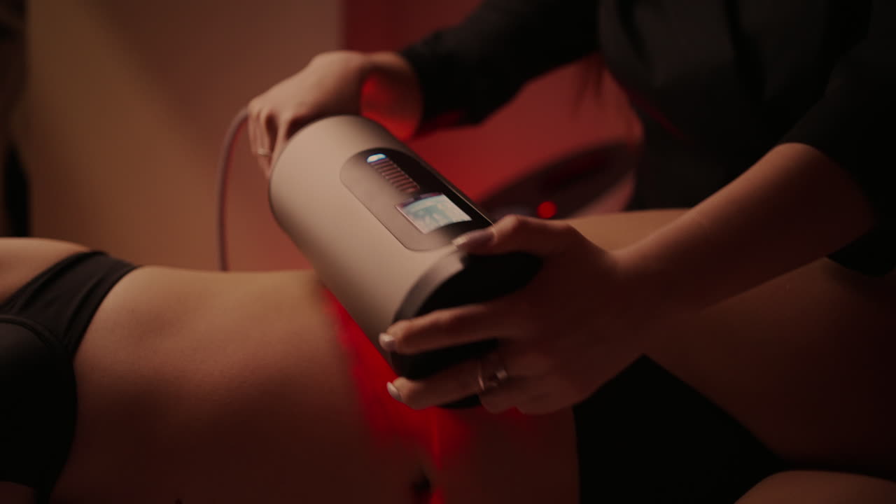 Woman receiving a body treatment with a massage machine