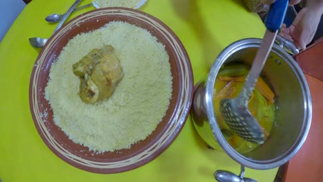 moroccan woman is serving traditional moroccan couscous