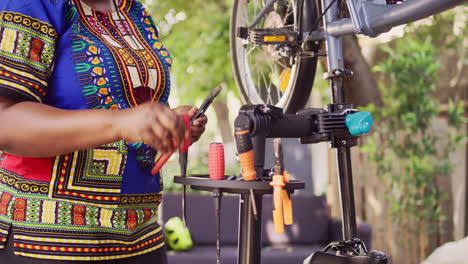 woman arranging tools to repair bicycle