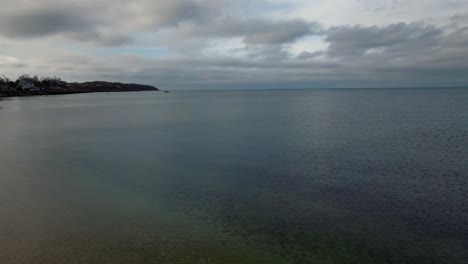 an aerial view of the quiet southold town beach in the off season