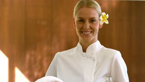 smiling beauty therapist holding tray of beauty treatments