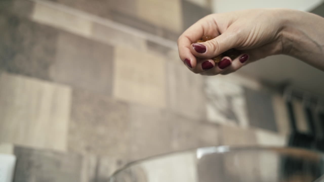 Woman pouring raisins into a bowl