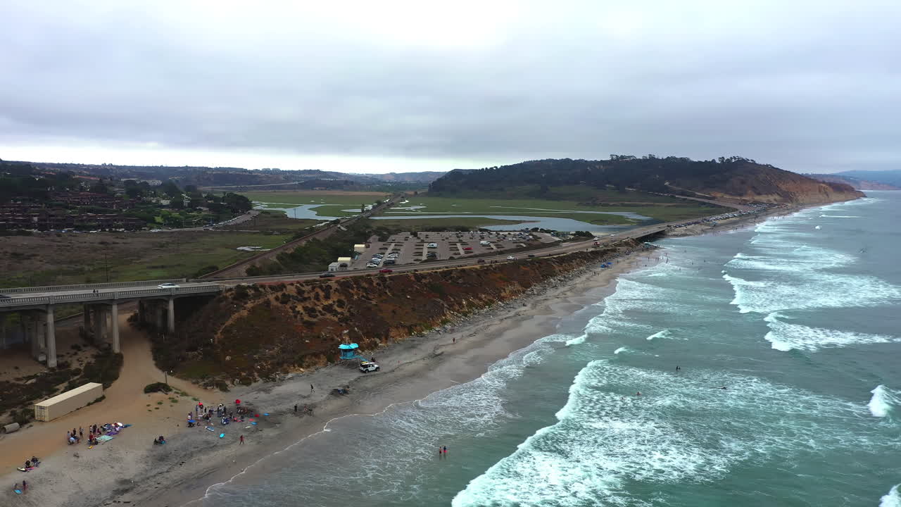 Foamy Sea Waves Washing Shore At Torrey Pines State Beach, San Diego, California - aerial drone shot
