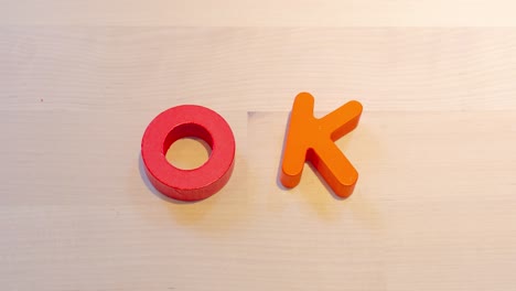 ok text stop motion animation on the wood desk approve or celebration concept