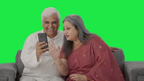 Happy-Old-Indian-couple-talking-on-video-call-Green-screen