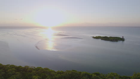 Drone-view-of-beach-with-bright-sky-and-sun