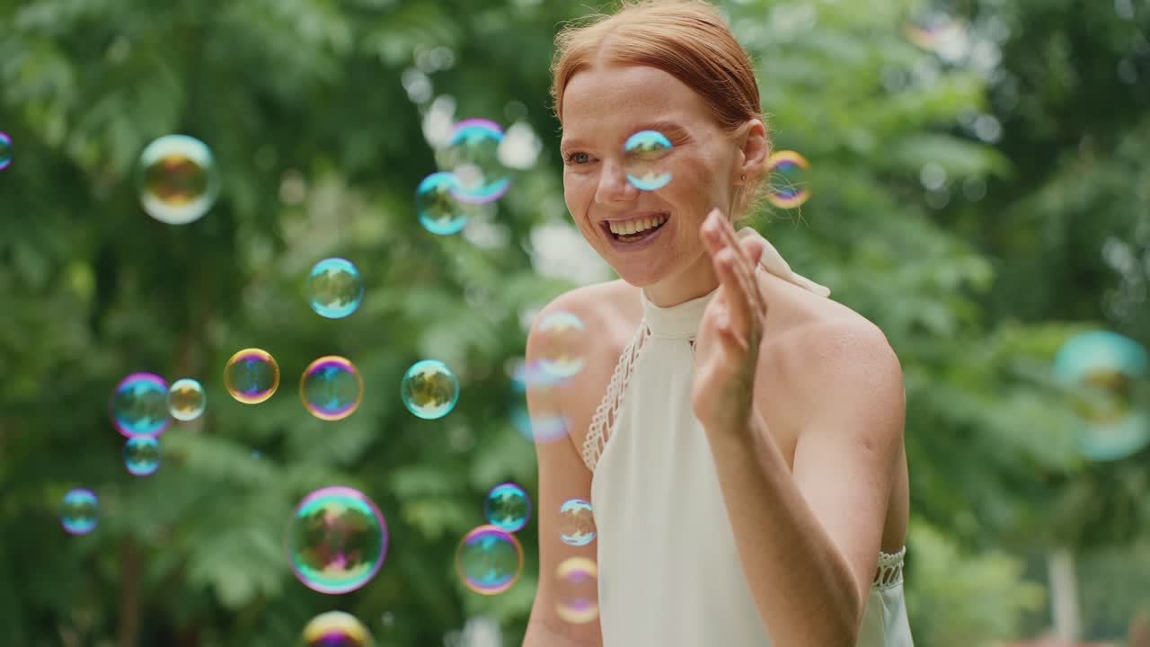 Woman Playing with Bubbles in Park