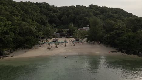 hidden beach in thailand between palmtrees