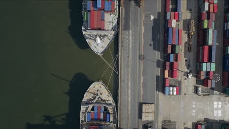 logistic concept aerial shot of commercial maritime transport dockyard with cargo ships waiting to be upload - offload cargo containers