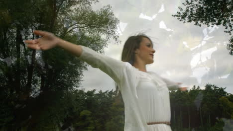 woman in white dress spinning in a forest