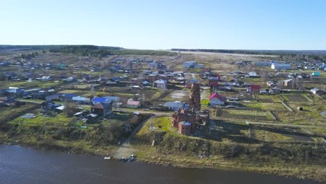 aerial view of a rural russian village with an old church