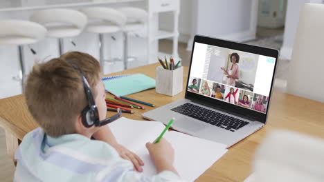 composite of boy using laptop for online lesson at home, with diverse teacher and class on screen