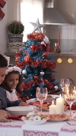 mother serving food to her happy family at christmas