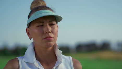 successful woman play golf at course. beautiful golfer face looking away outside