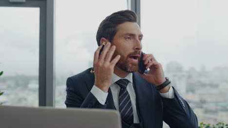 man banker calling client having nervous conversation in office close up.