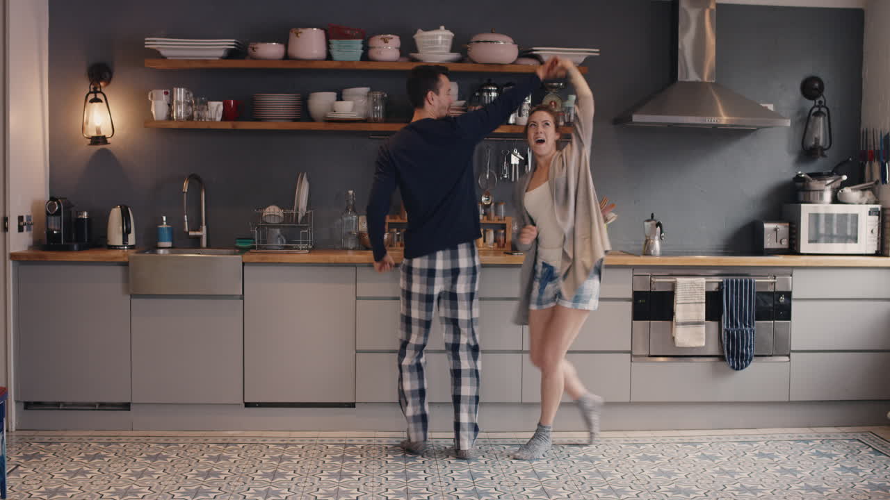 행복 한 신혼 부부 는 부 ⁇  에서 음악 을 듣고 피자마 를 입고 집 에서 아침 커피 를 마시고 춤 을 추고 있다