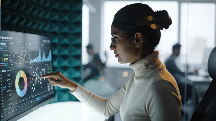 Focused Professional Analyzing Data on a High-Tech Monitor in a Modern Office Environment, Showcasing Trends and Insights with Charts and Graphs